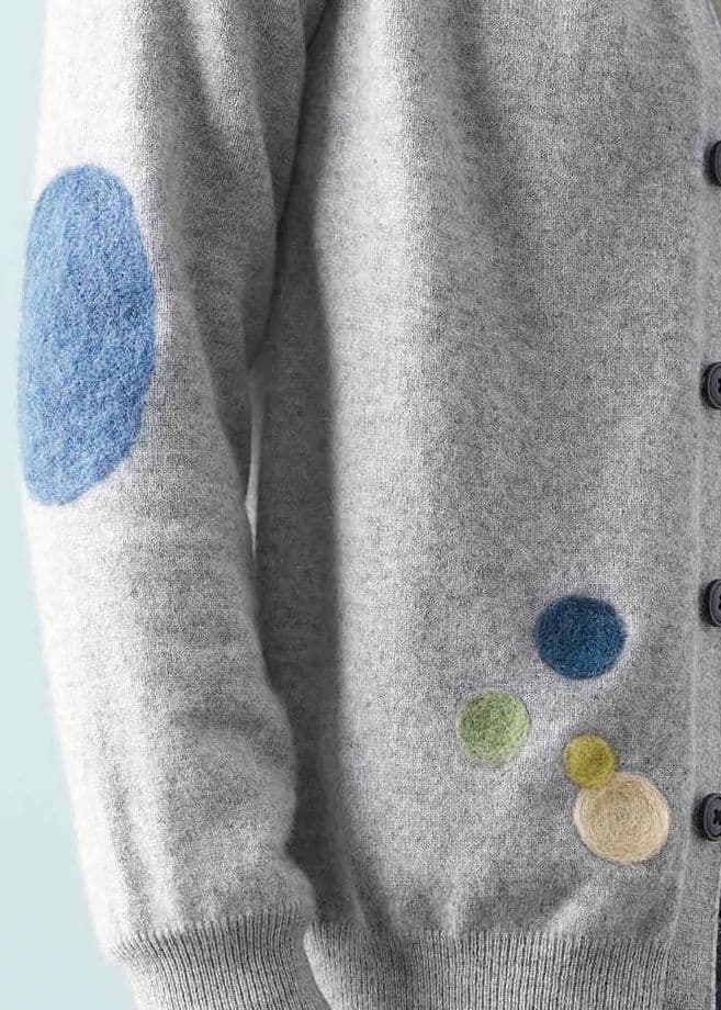 Colored felt circles on a gray wool jacket