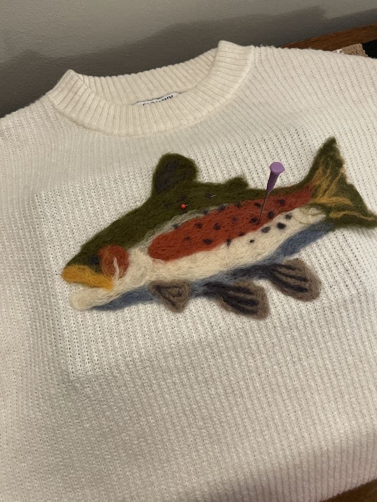 Felt fish on a white wool sweater