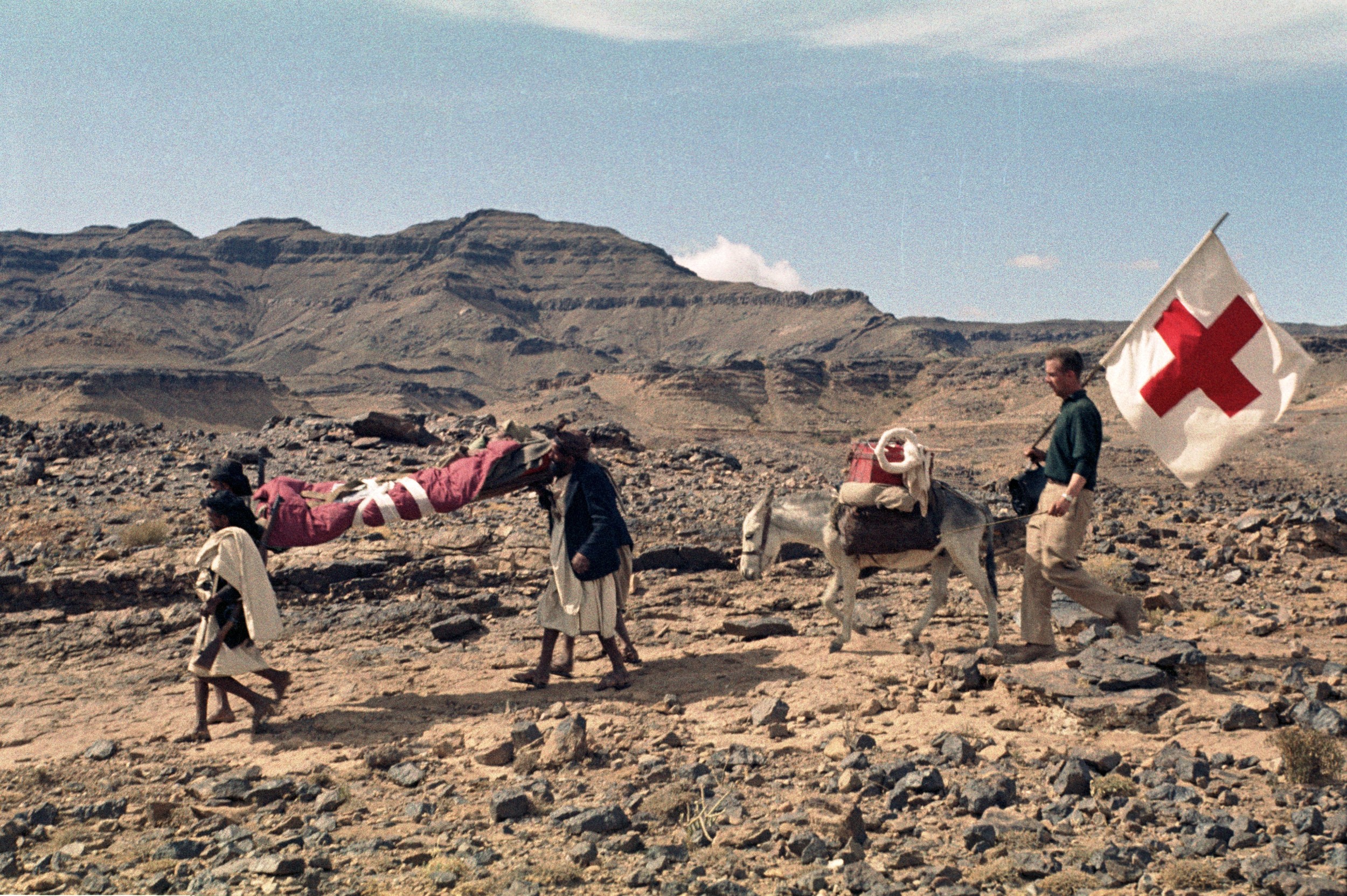 ICRC delegate Marcel Boisard evacuating a wounded man